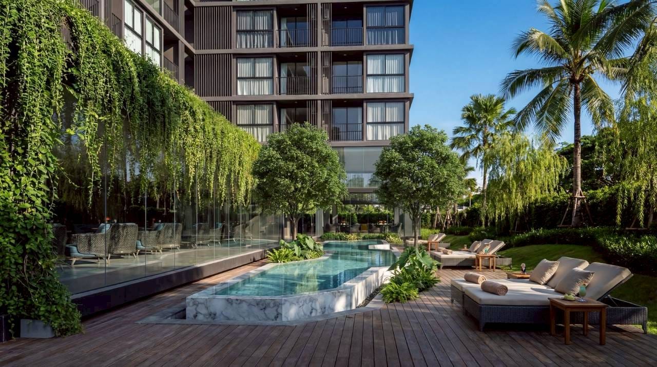 1-Bedroom Condominium for Sale in Chalong, Phuket — Pool deck and loungers in daylight, Soi Ta-iad